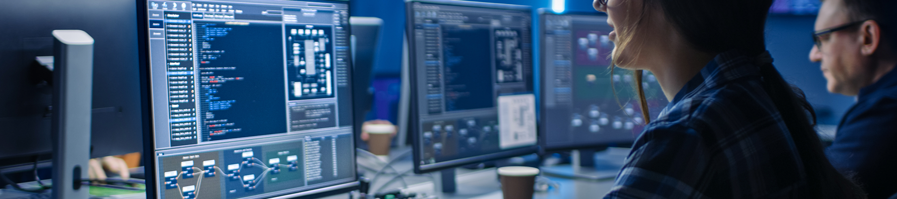 woman and man coding on computers