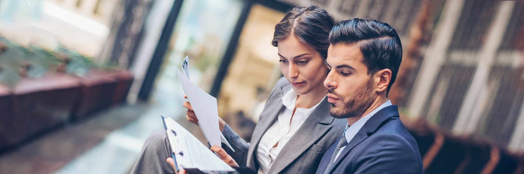 Woman and man reviewing documents on a clipboard