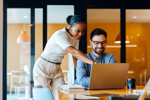 Two people looking at a computer together