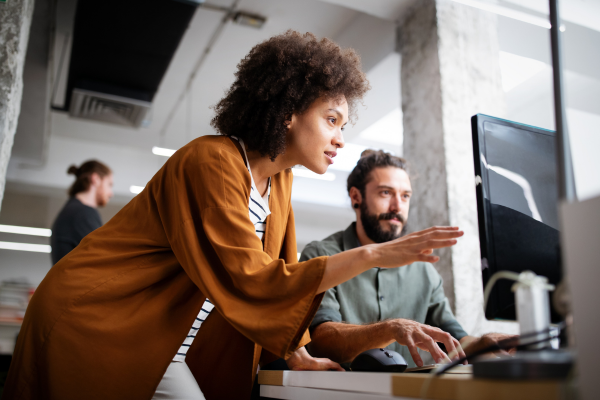Two people studying computer data