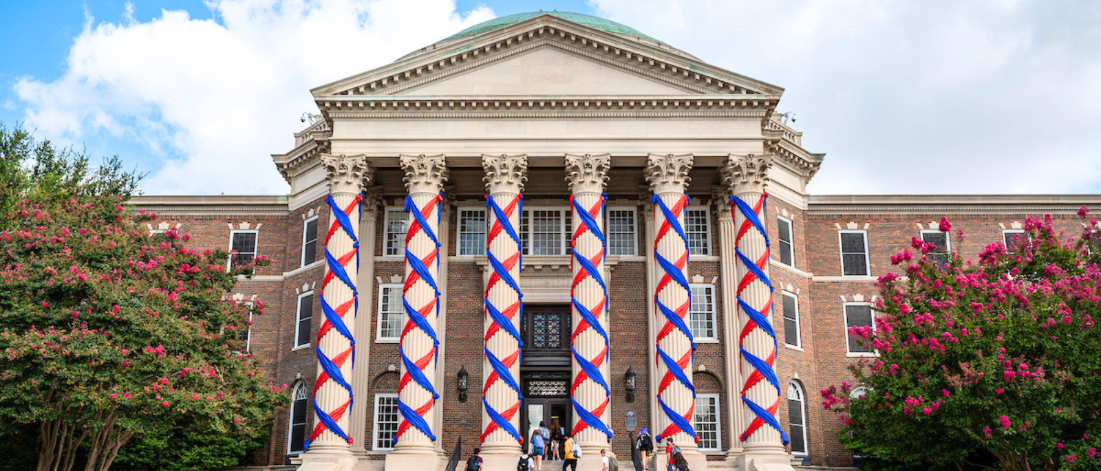 SMU Dallas Hall decorated with red and blue ribbons