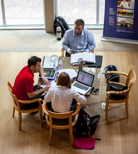 three students at a table working