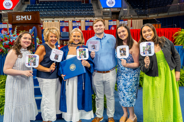 family holds up graduation fans