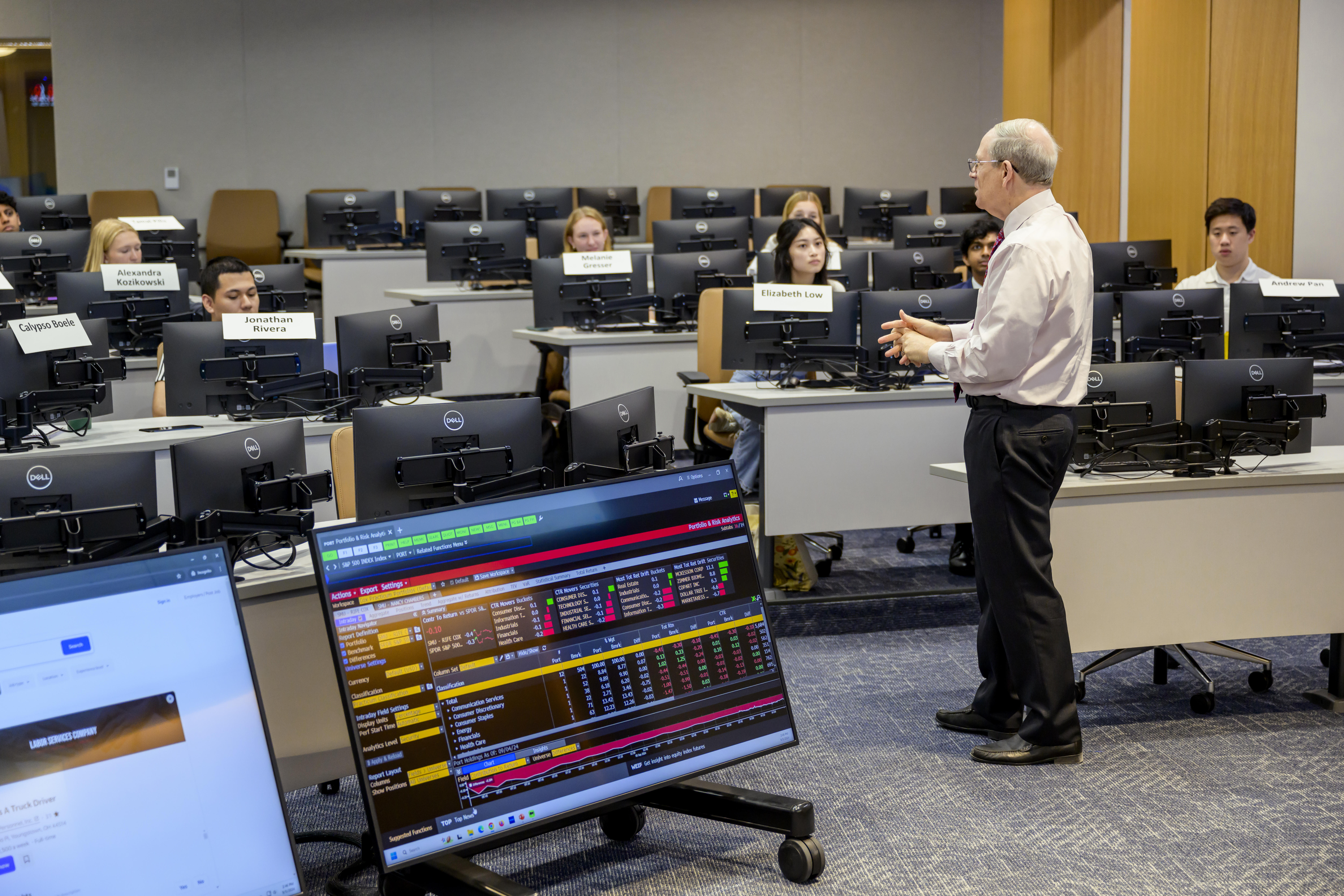 professor stands in front of classroom