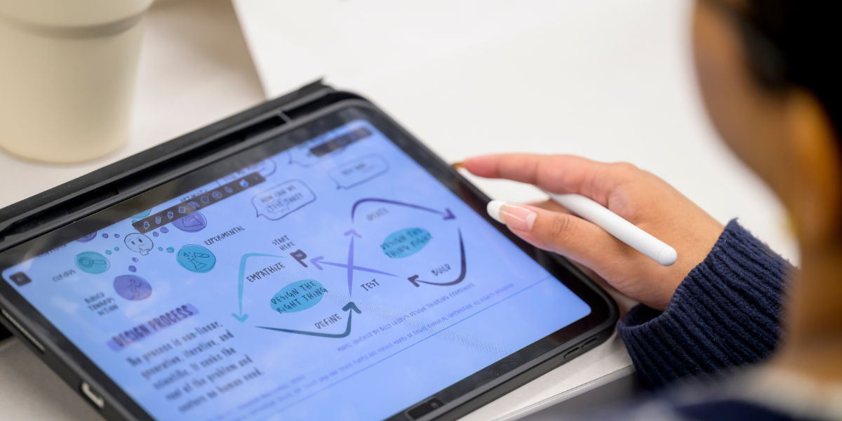 photo of student holding tablet with AI design 