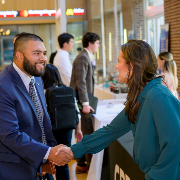 student networking with employer at event