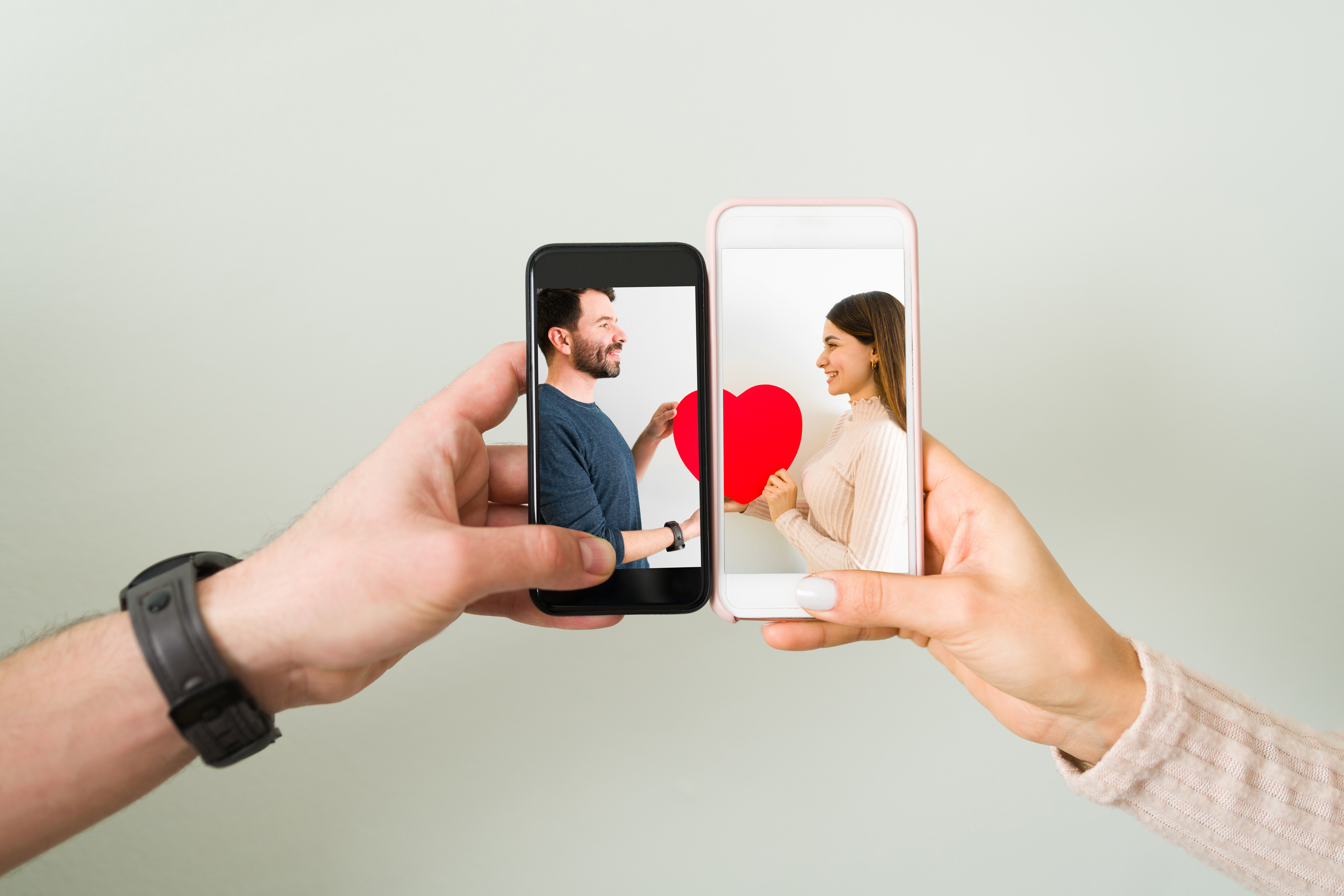 Photo of two phones being held together, completing a heart image