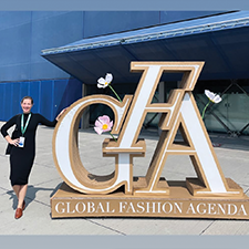 Lacie Thorne stands with a Global Fashion Agenda sign