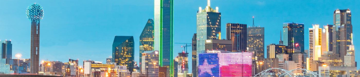 Photo of the dallas skyline with texas flag on the omni hotel