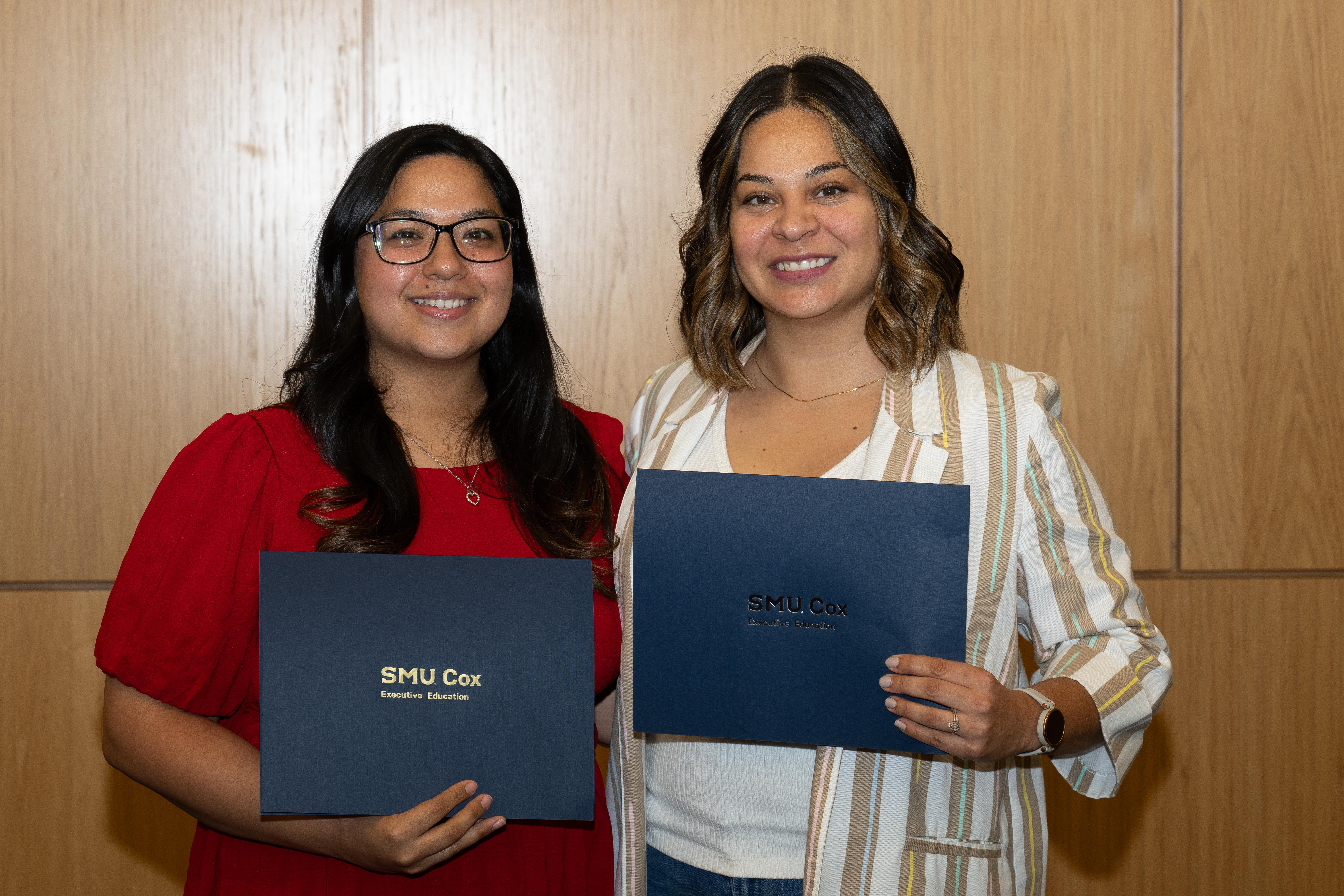 Graduates holding diploma