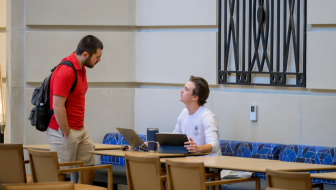 students discuss homework at the Cox School