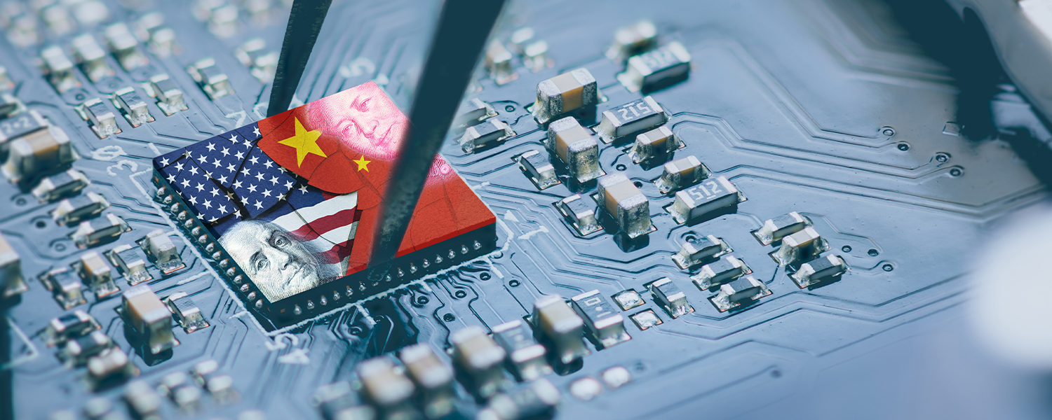 A photo of a computer board. A CPU is in the middle of it. Half of it is colored with the US flag, the other half with the Chinese flag.