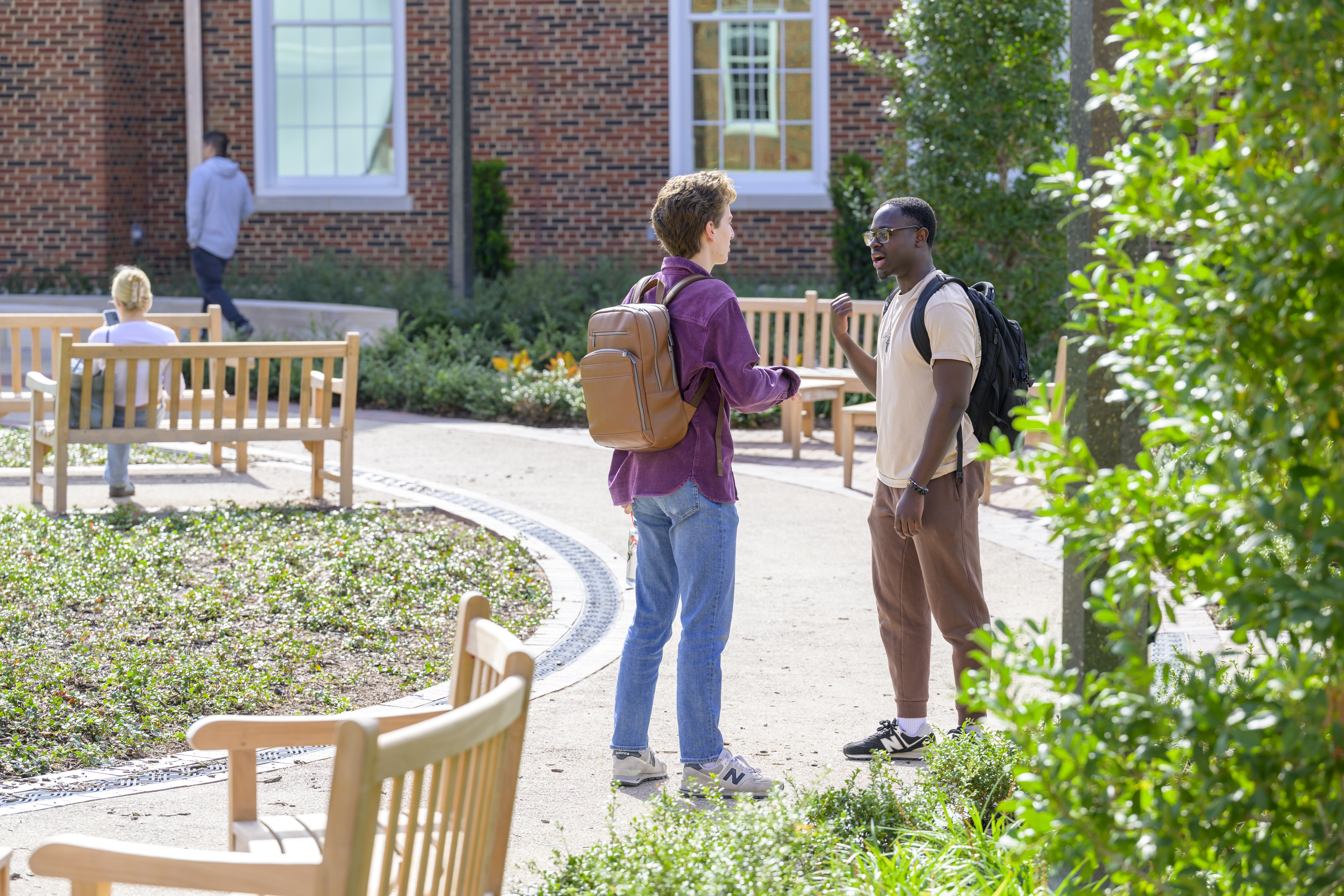photo of two students talking outside of Cox School