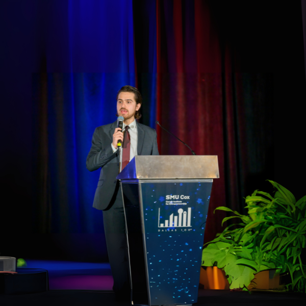 photo of man at Caruth Dallas 100 podium