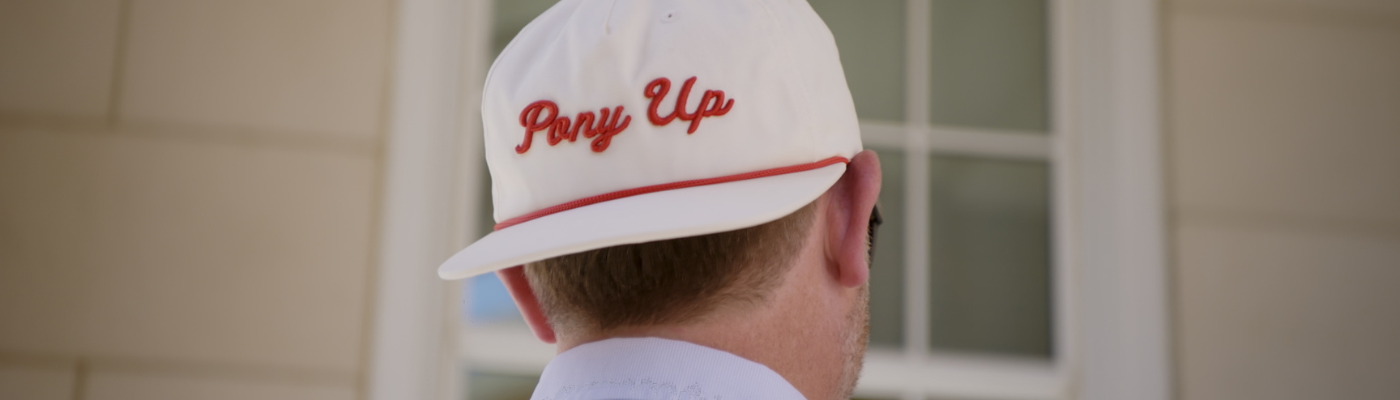 photo of student with Pony Up hat