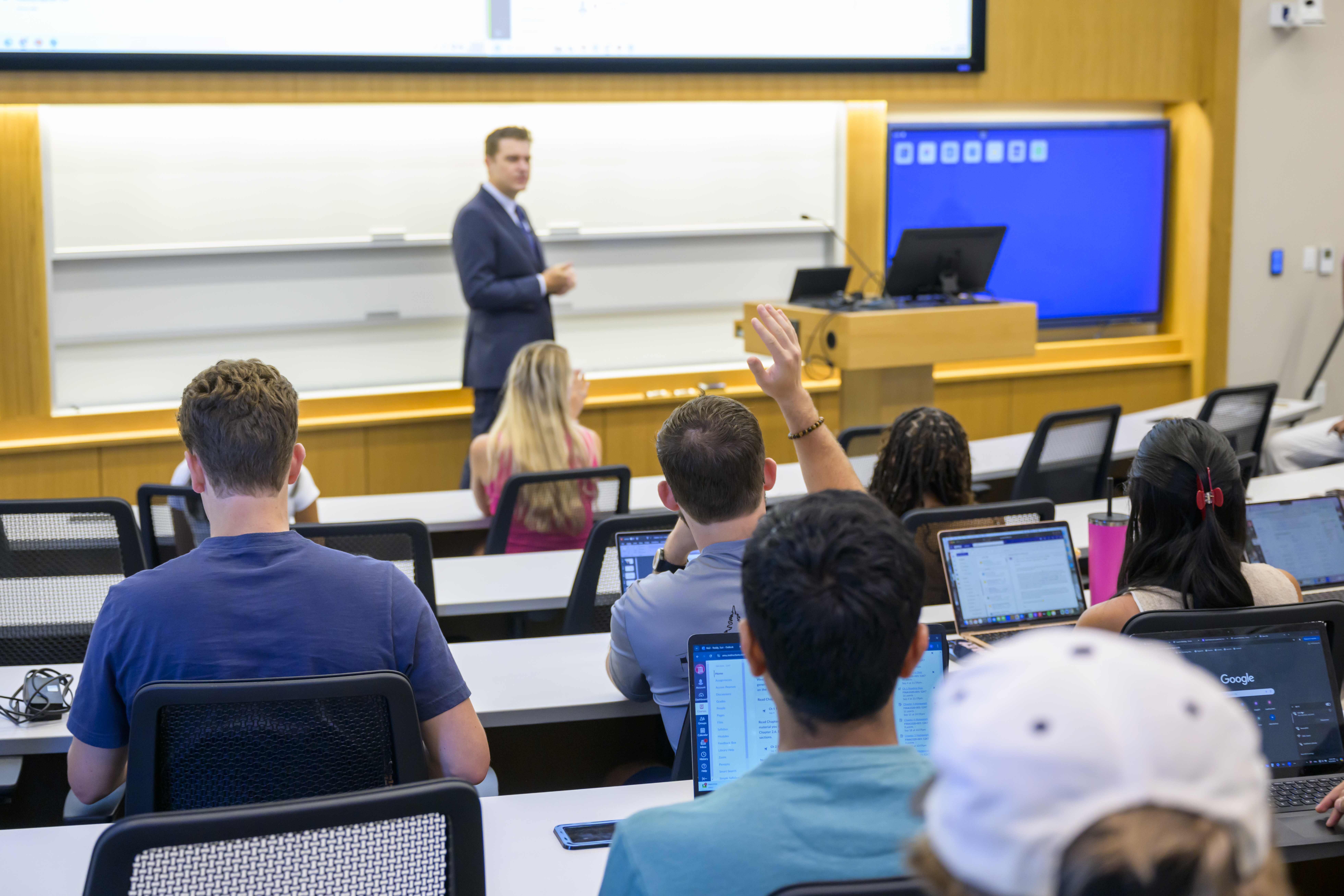 Student raises hand in Cox classroom