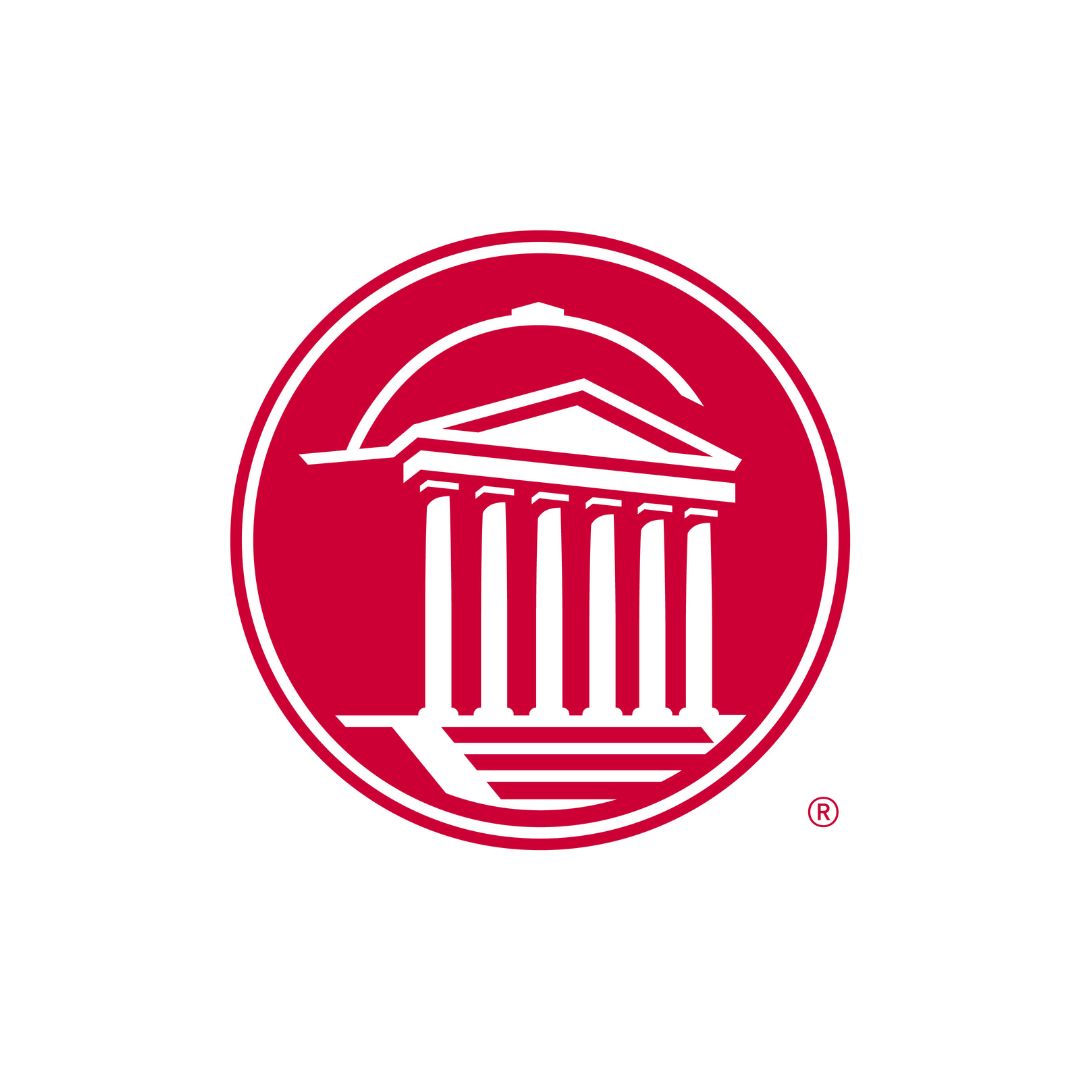 Red and white round emblem of Dallas Hall
