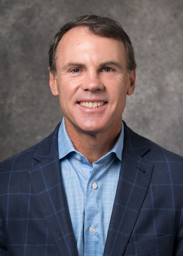 Brian Fox in a blue shirt and blue suit jacket