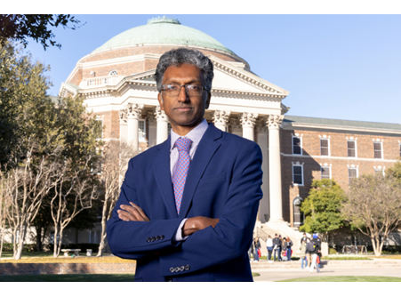 Outdoor portrait of the Dean, Janan Jayawickramarajah in front of Dallas Hall