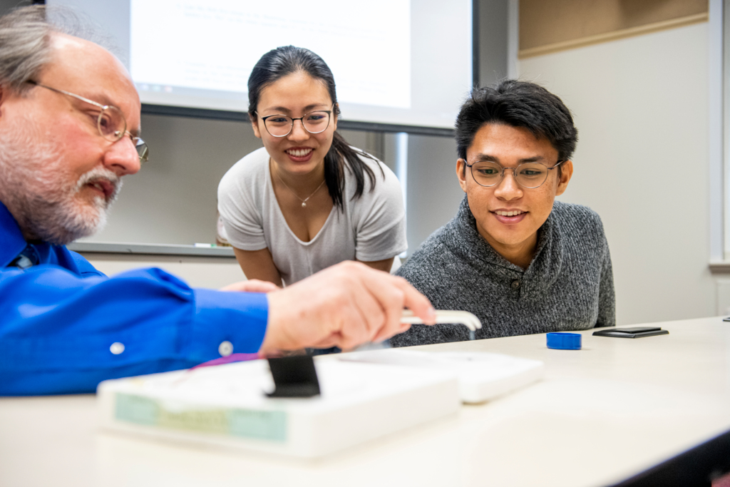 physics professor with students