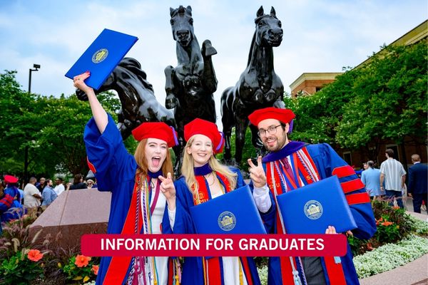 Picture of three phd candidates celebrating graduation with diplomas