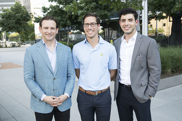 Three People Standing and smiling at Camera. 