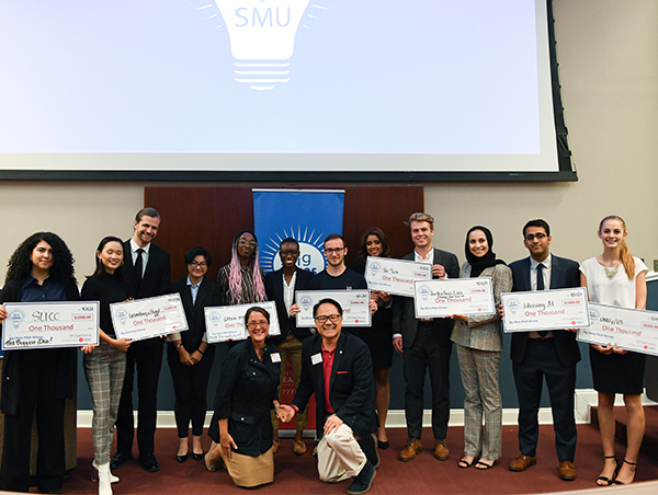 Group of students on stage holding certificates.