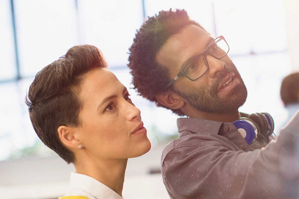 Two People Working on a Whiteboard.