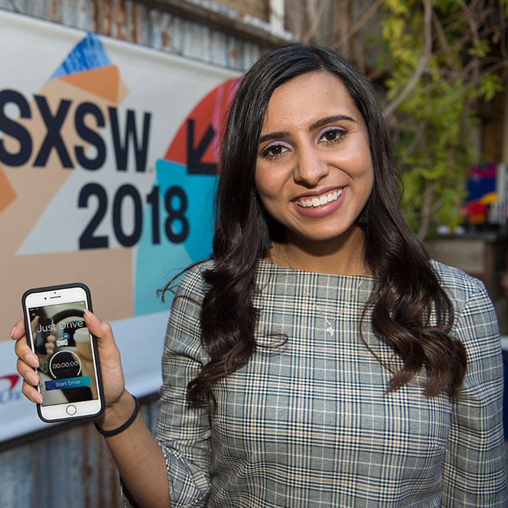 Student Neha Husein Holding a Phone. 