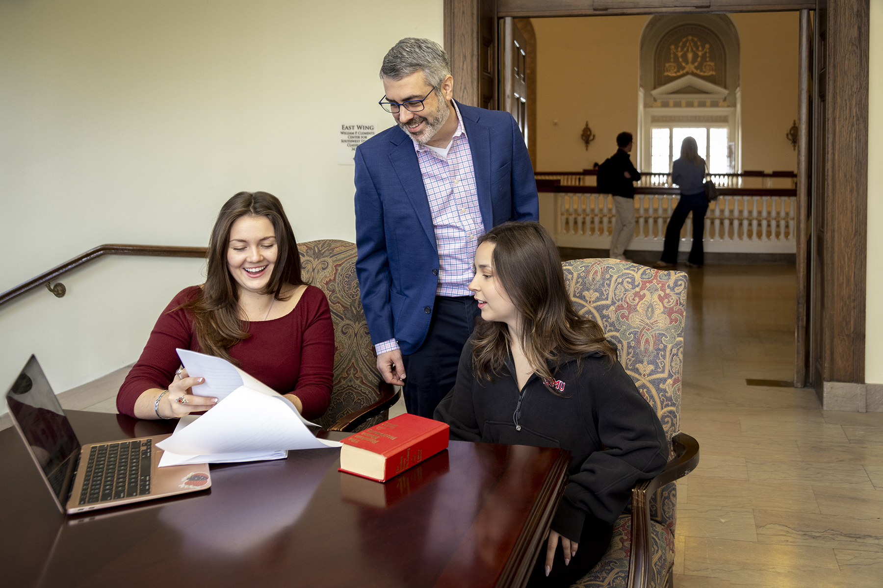 Associate Professor and Director of Undergraduate Studies Dan Moss reviews a project with English students on the third floor of Dallas Hall.