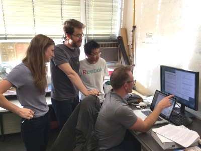 students looking at computer