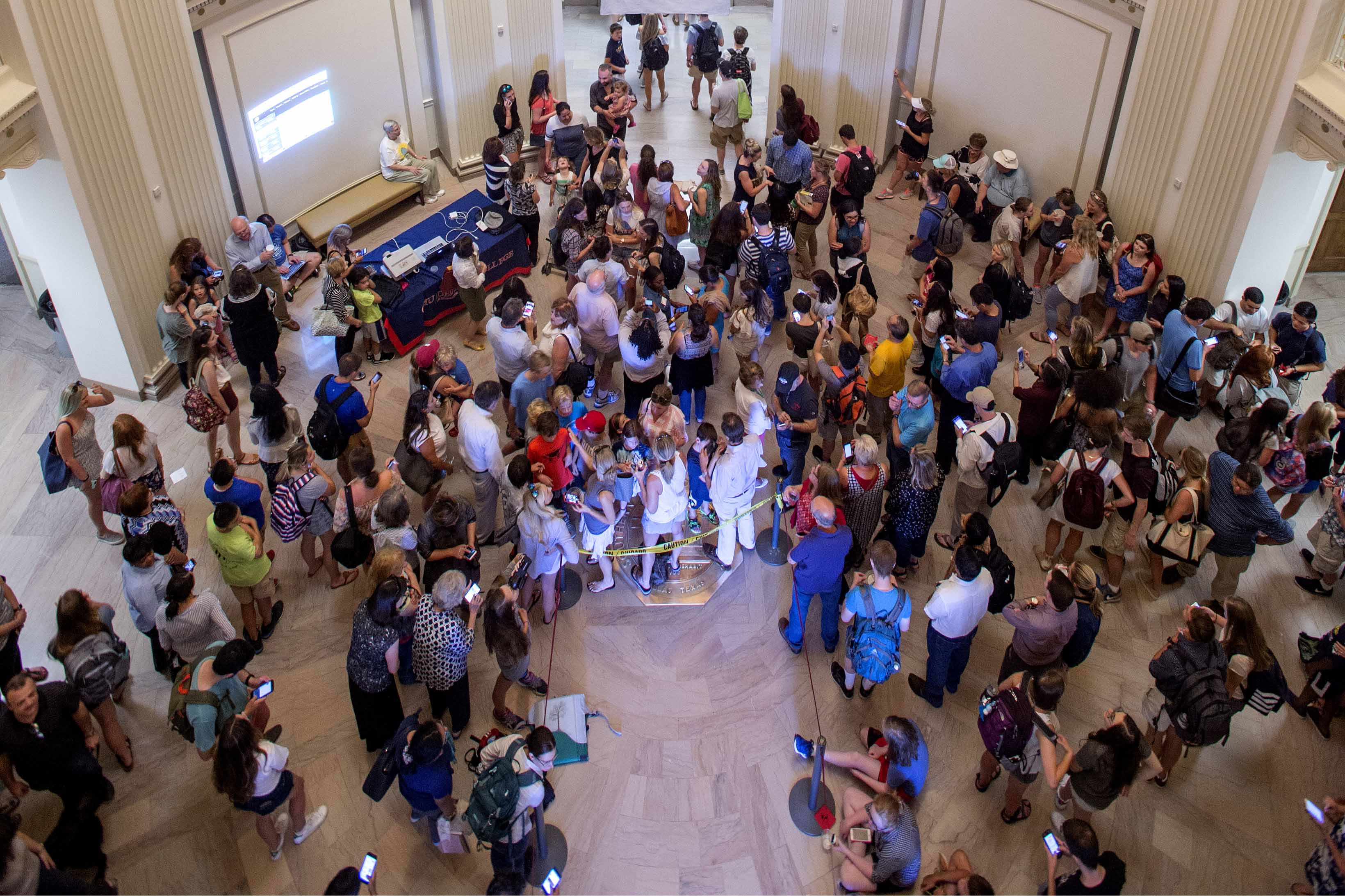 students in the Dallas Hall rotunda