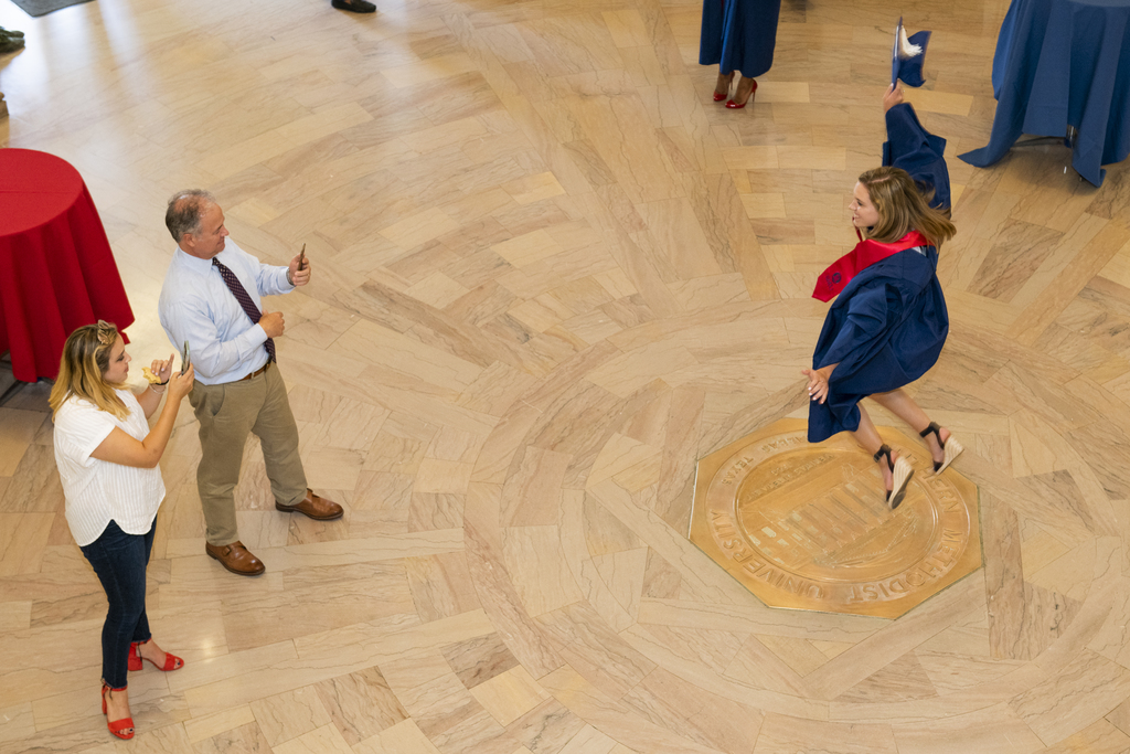 Girl jumping in Dallas Hall Rotunda