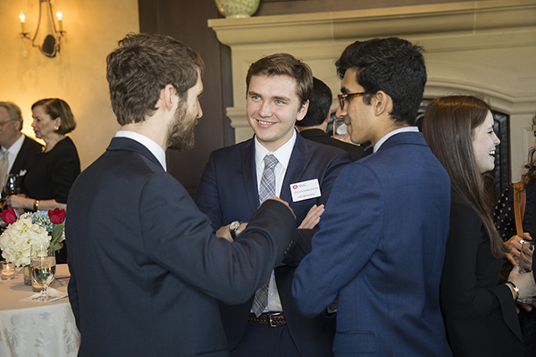 three students in suits