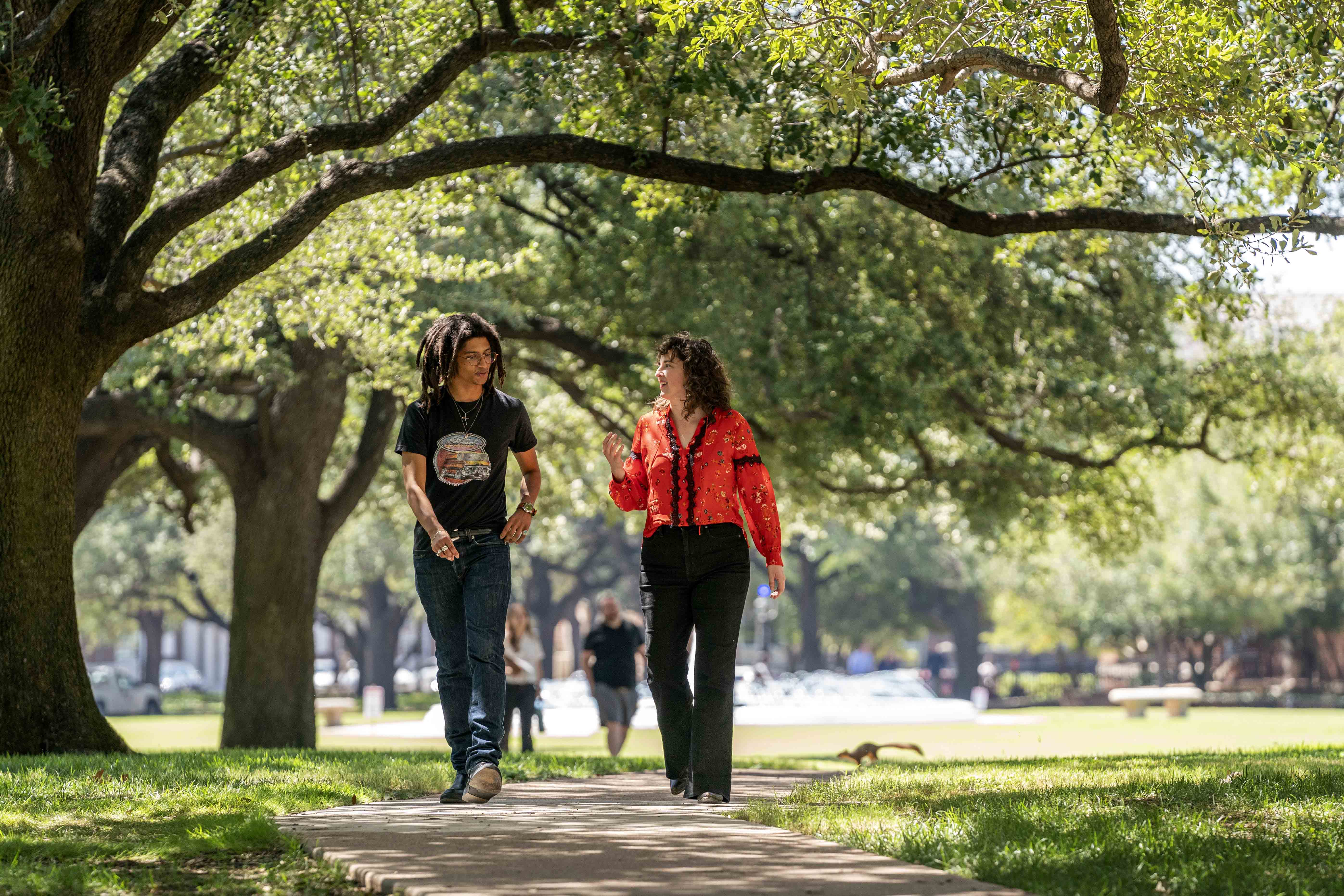student and professor walking outside