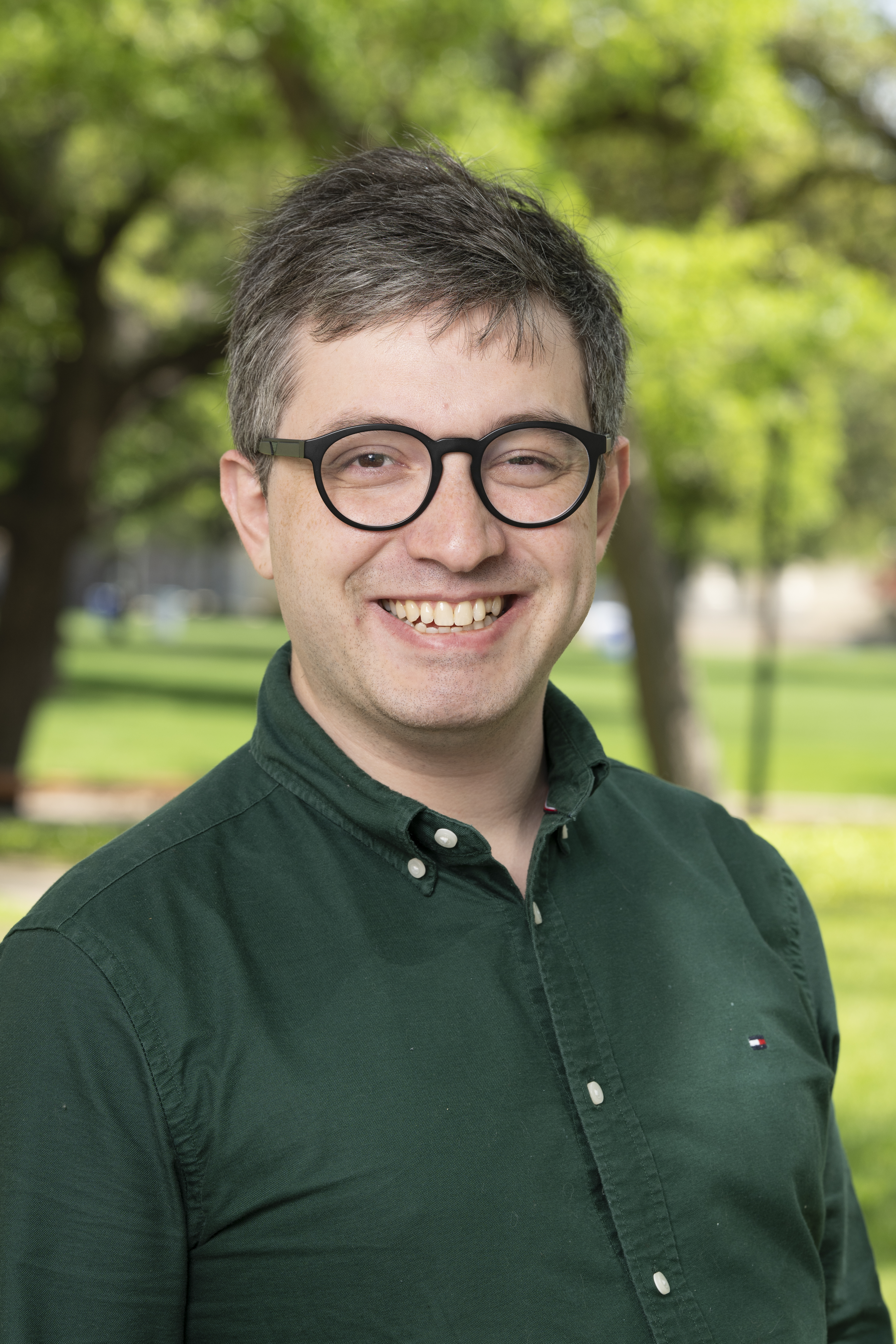 Outdoor portrait of professor Alipio Ferreira wearing a green button up shirt