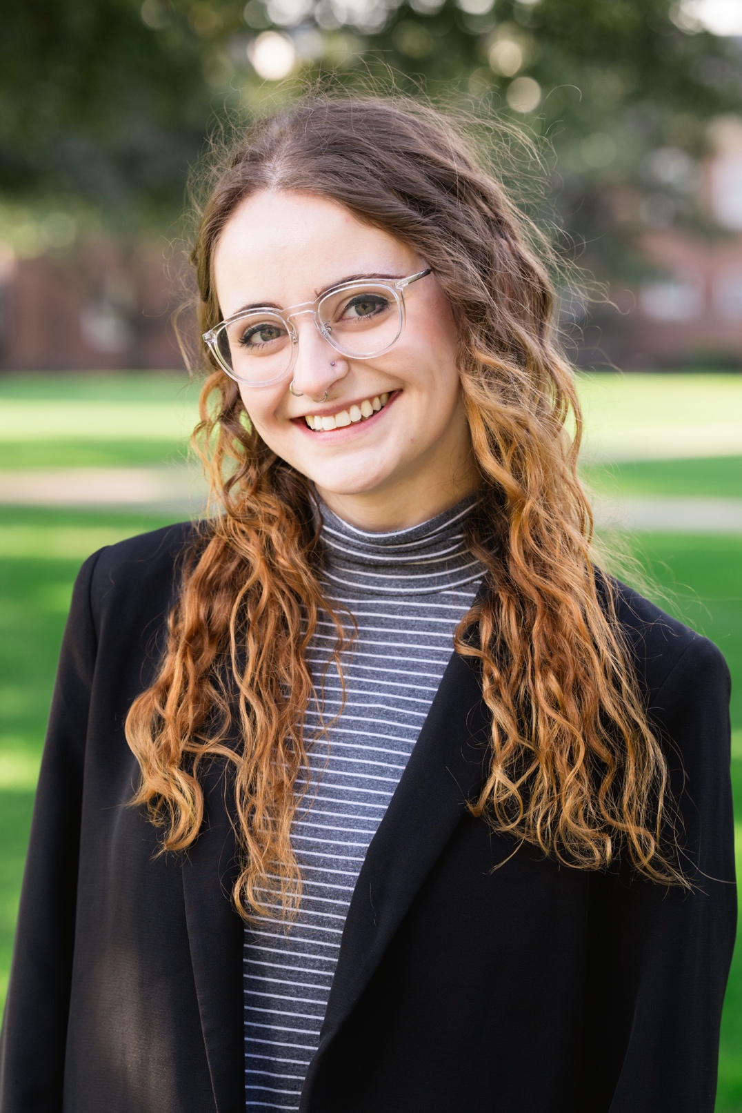 Emma Armstrong wearing a gray turtleneck and black blazer
