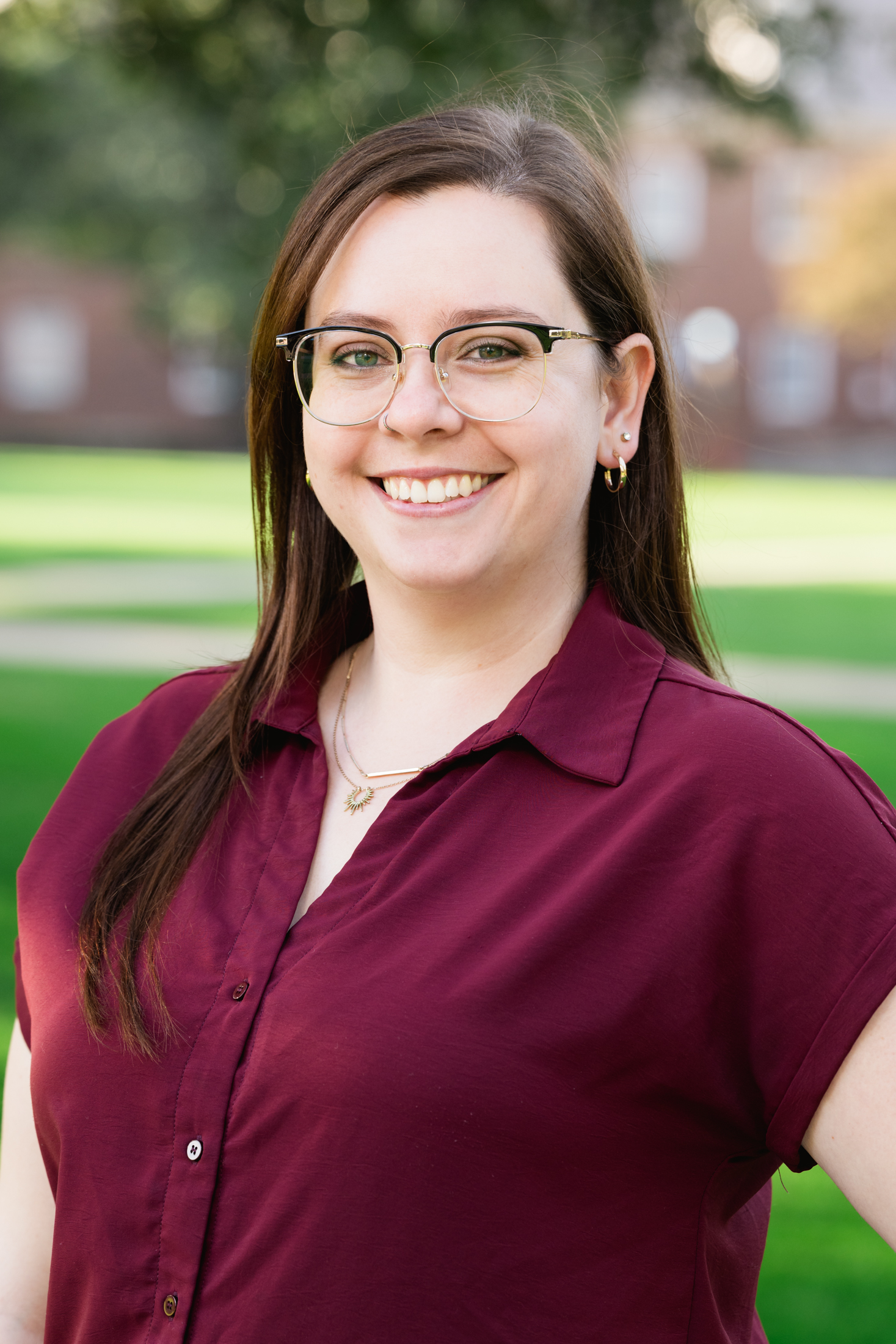Katie Denney wearing a red button up blouse