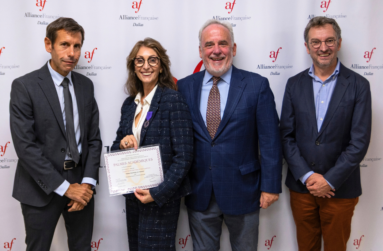 Paola Buckley standing for a photo alongside the Consulate General of France in Houston, Frank Marchetti