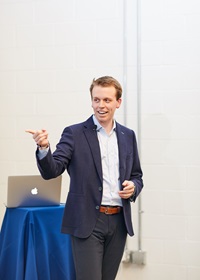 Kyle Waldrep presents to a crowd.