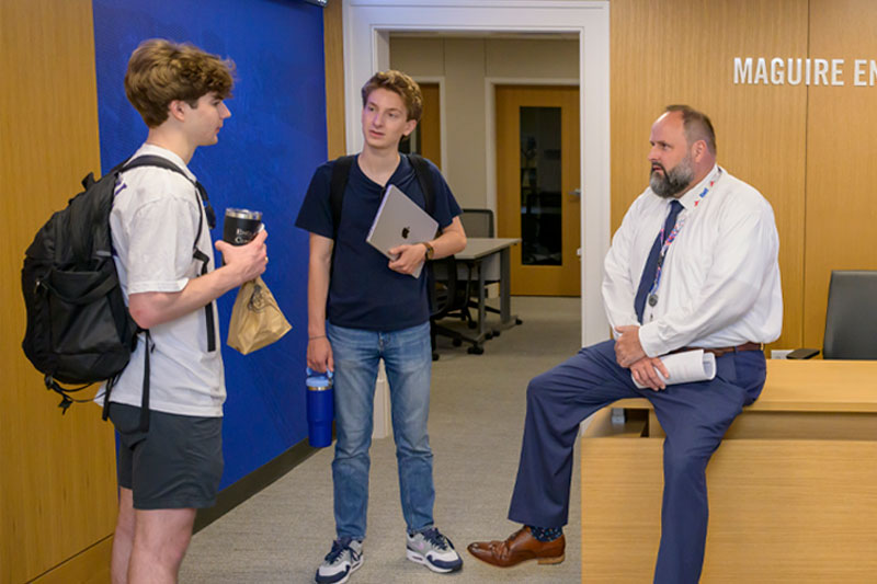 BBA Scholars - students talking with a professor