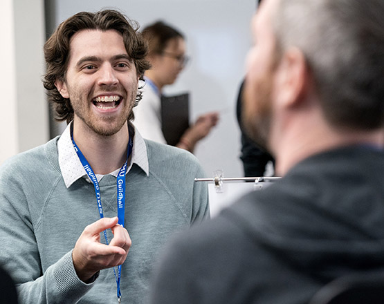 A photo of a SMU Guildhall student networking with a game industry recruiter