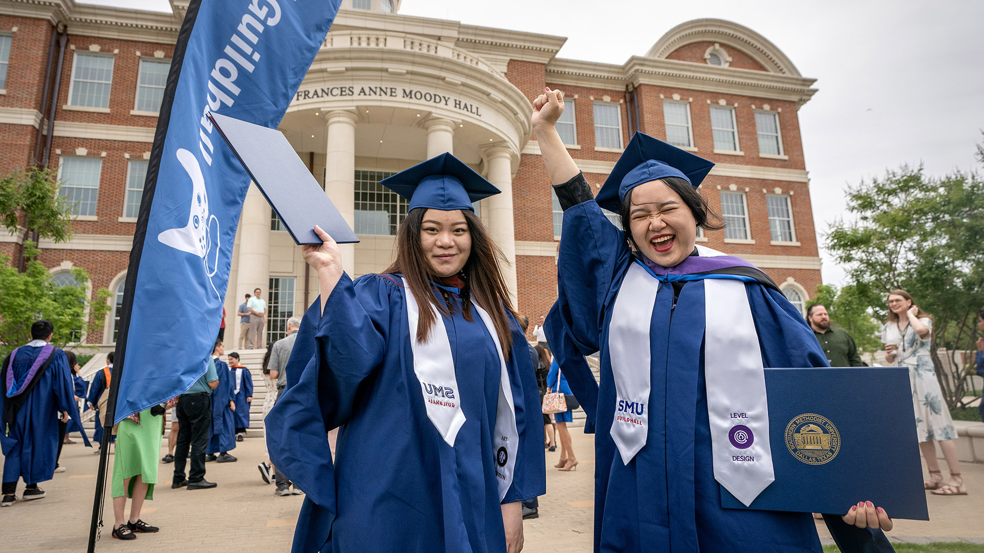 Photo of SMU Guildhall students celebrating at graduation