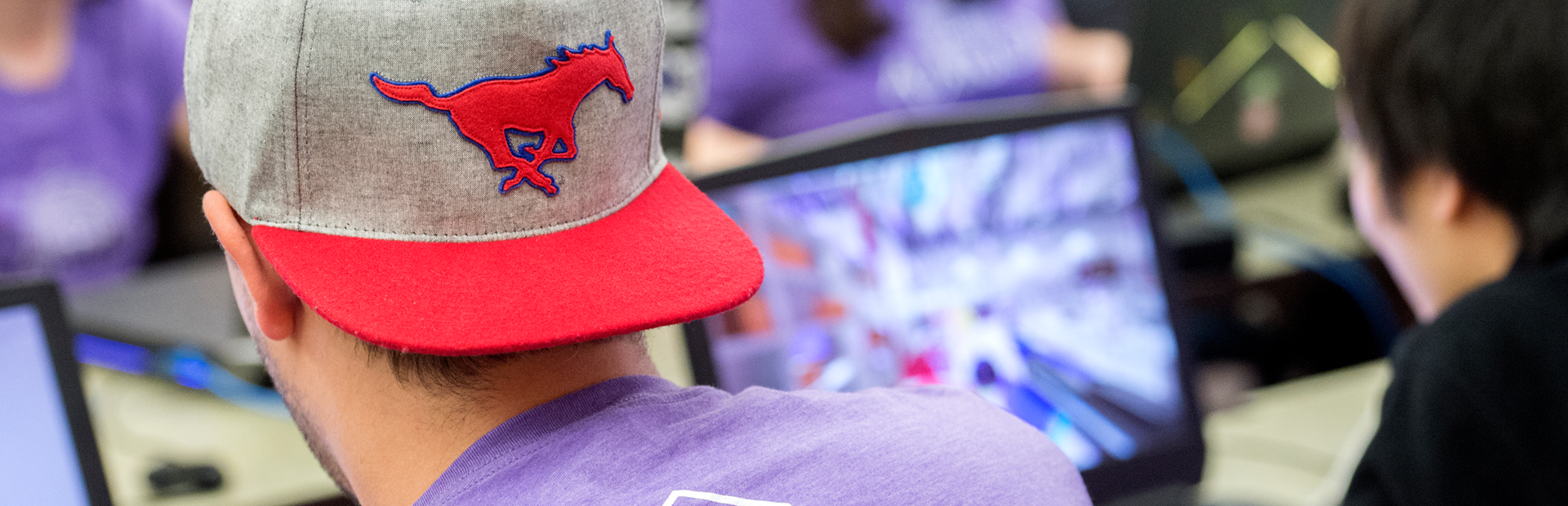 SMU Guildhall student with Peruna hat