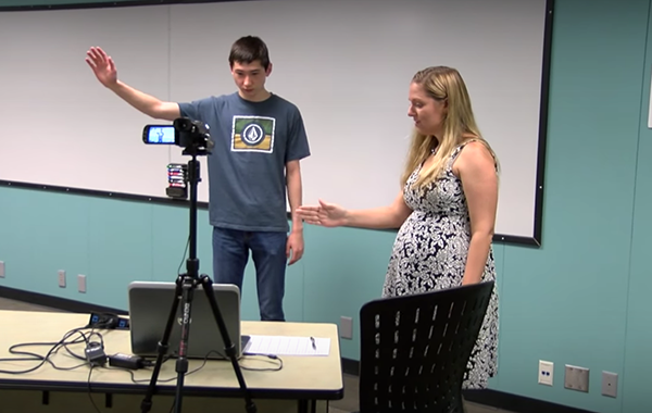 A photo of SMU Researcher Candace Walkington working with a student on the Hidden Village project