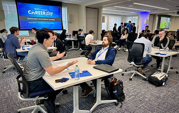 Photo of student and game industry professional networking at SMU Guildhall Career Day 2026