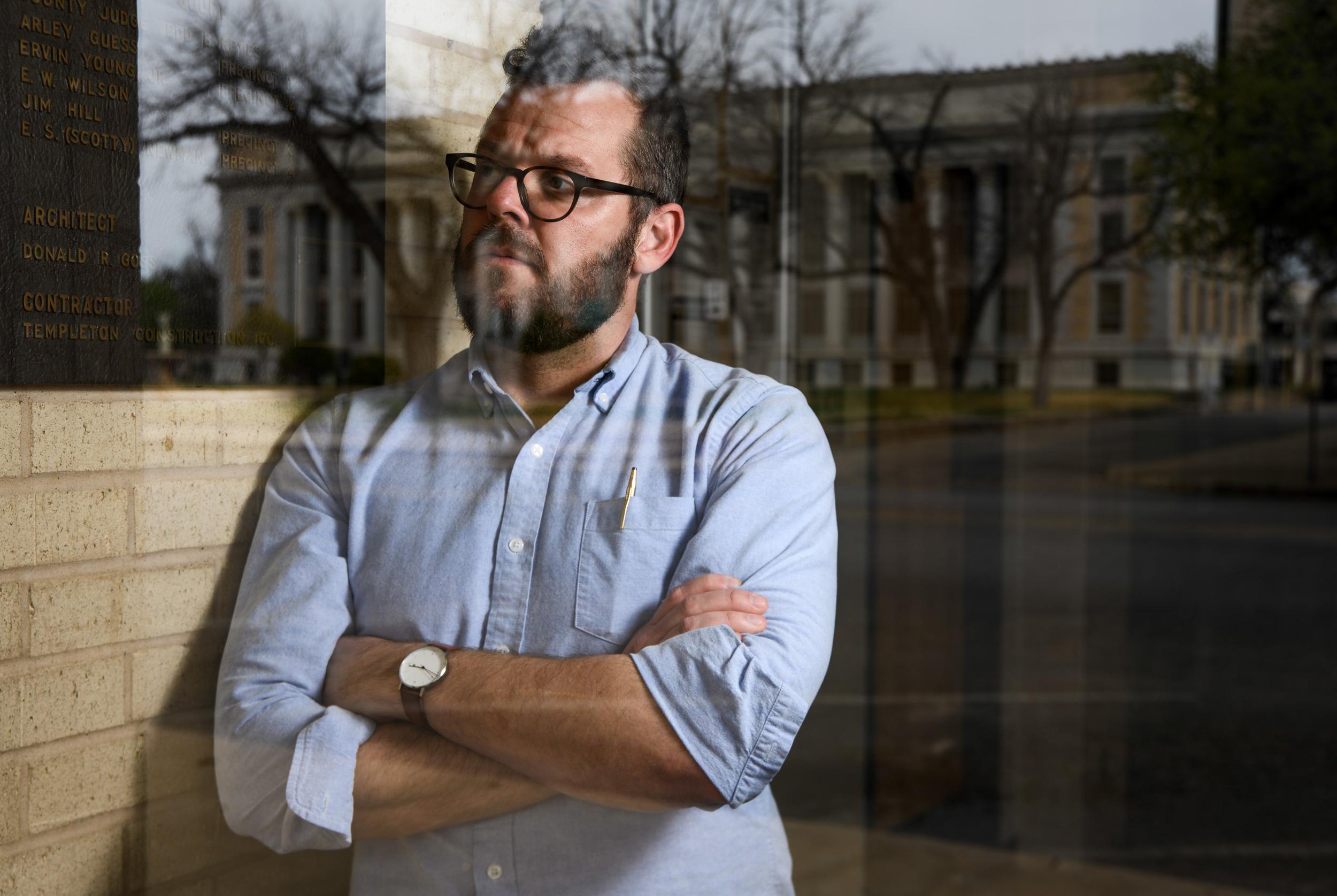man leaning on a window