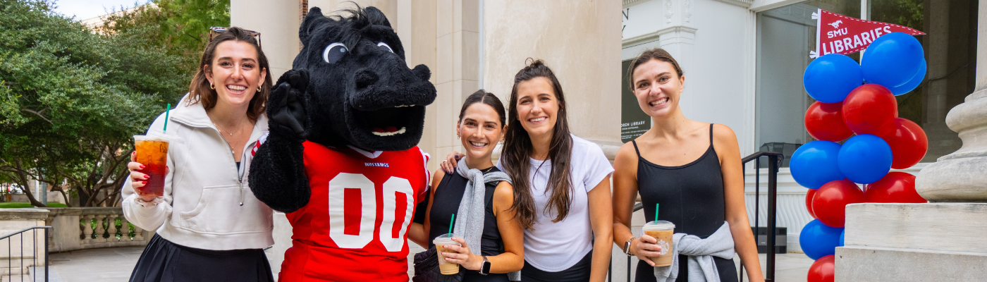 students pose with Peruna on the steps of Fondren Library