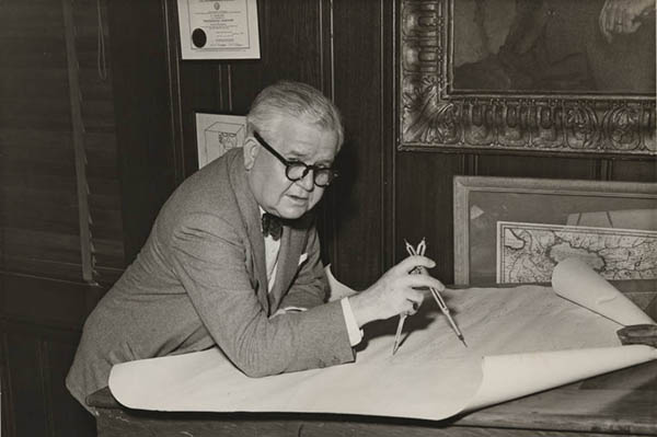 mr. degolyer holding compass while charting map