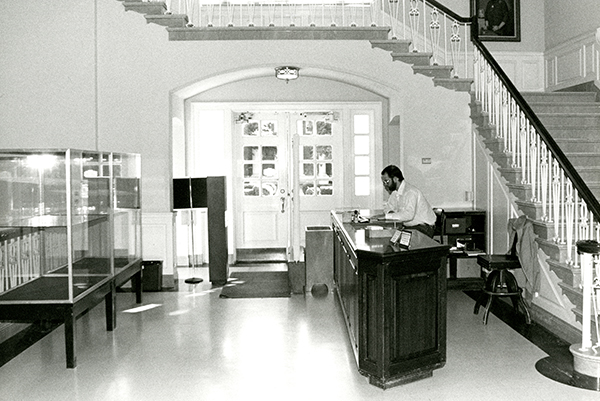 Circulation desk pre-remodel, David John Lawrence at the desk